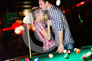 Young attractive couple on date in snooker club