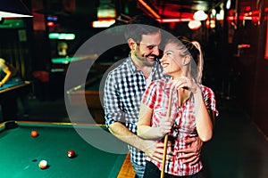 Young attractive couple on date in snooker club