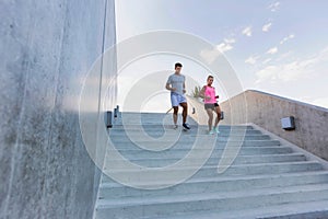 Young attractive couple exercising in stairs