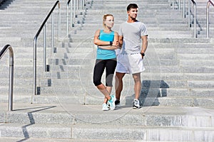 Young attractive couple exercising in stairs