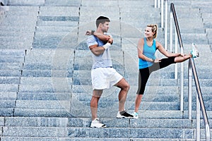 Young attractive couple exercising in stairs