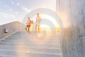 Young attractive couple exercising in stairs
