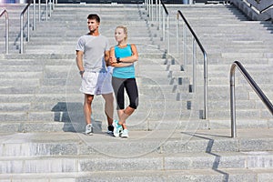 Young attractive couple exercising in stairs