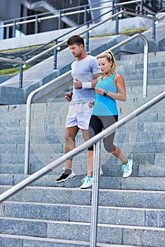 Young attractive couple exercising in stairs