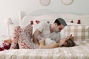 Young attractive couple having romantic time in bed