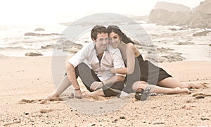 Young attractive couple laughing on beach