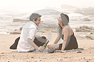 Young attractive couple laughing on beach