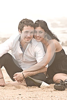 Young attractive couple sharing a moment on beach