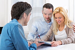 Young attractive couple signing contract photo