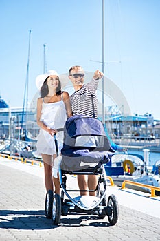 Young and attractive couple walking with their baby