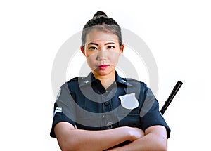 Young attractive and defiant Asian Chinese police officer in uniform holding defense stick serious isolated on white background in