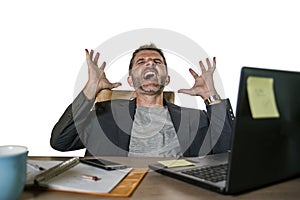 Young attractive depressed and frustrated businessman working at office computer desk desperate and overwhelmed feeling upset