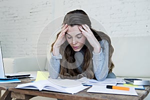 Young attractive and desperate woman suffering stress doing domestic accounting