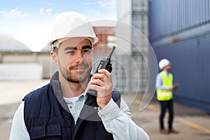 Young Attractive docker using talkie walkie at work