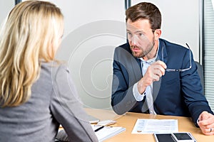 Young attractive employer doing a job interview to a woman