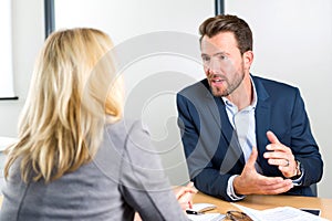 Young attractive employer doing a job interview to a woman