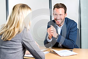 Young attractive employer doing a job interview to a woman