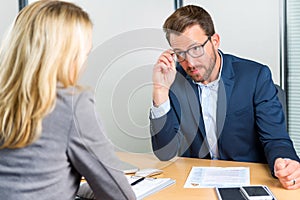 Young attractive employer doing a job interview to a woman