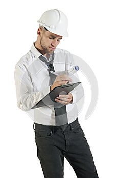 Young attractive engineer writing down notes on clipboard