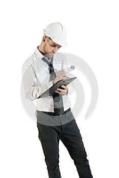 Young attractive engineer writing down notes on clipboard