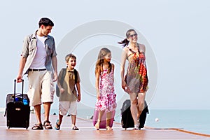 A young and attractive family with their luggages.