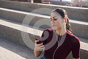 Young attractive female with cell phone on stairs