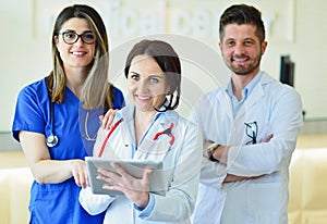 Young Attractive female doctor in front of medical group.