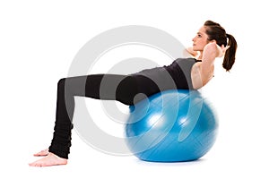 Young attractive female exercise using ball