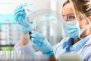 Young attractive female scientist researching in the laboratory