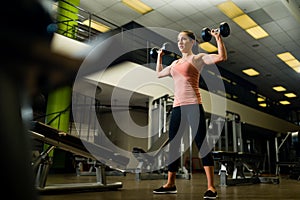 Young attractive female working out in a gym