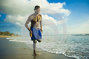 Young attractive fit athletic and strong black African American man running at the beach training hard and sprinting on sea water