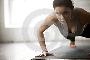 Young attractive fitness woman practicing Push ups