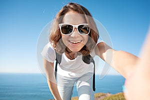 Young attractive funny girl in a white T-shirt and jeans against