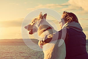 Young attractive girl with her pet dog at a beach photo