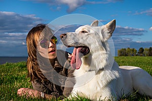 Young attractive girl with her pet dog at seaside