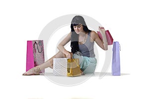 Young attractive girl sitting with all her new purchases