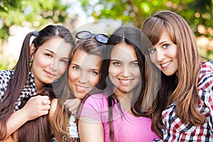 Young and attractive girlfriends have fun in park