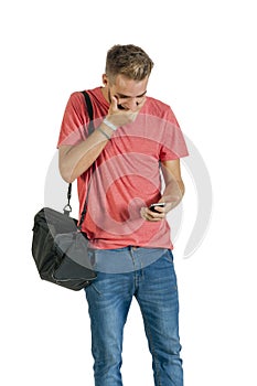 Young attractive guy laughing at message on his mobile phone