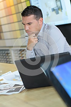 Young attractive and handsome businessman working on computer