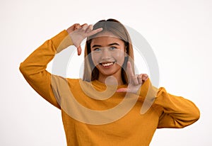 Young attractive happy asian girl posing in studio