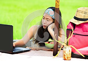 Young attractive and happy Asian Korean digital nomad working outdoors relaxed with laptop computer at tropical cafe in success on