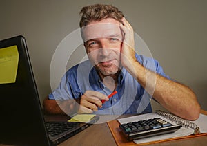 Young attractive and happy business man working with laptop computer at home office smiling satisfied and confident in successful