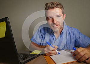 Young attractive and happy business man working with laptop computer at home office smiling satisfied and confident in successful