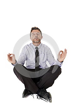 Young attractive happy businessman relaxing with hands in yoga position sitting on the floor