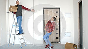 A young attractive happy couple moving into a new home.