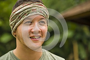 Young attractive and happy hipster man enjoying tropical nature exploring exotic Asian tourist destination during holiday trip