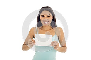 Young attractive and happy hispanic woman holding blank card with copy space