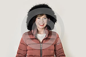 Young attractive and happy red hair Caucasian woman on her 20s or 30s posing cheerful and smiling wearing warm winter jacket