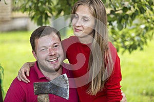 Young attractive happy romantic couple, pretty blond long-haired smiling girl and laughing unshaven man hugging together outdoors