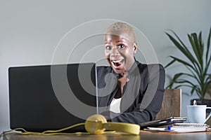 Young attractive and happy successful black afro american woman in business jacket working cheerful at office laptop computer desk